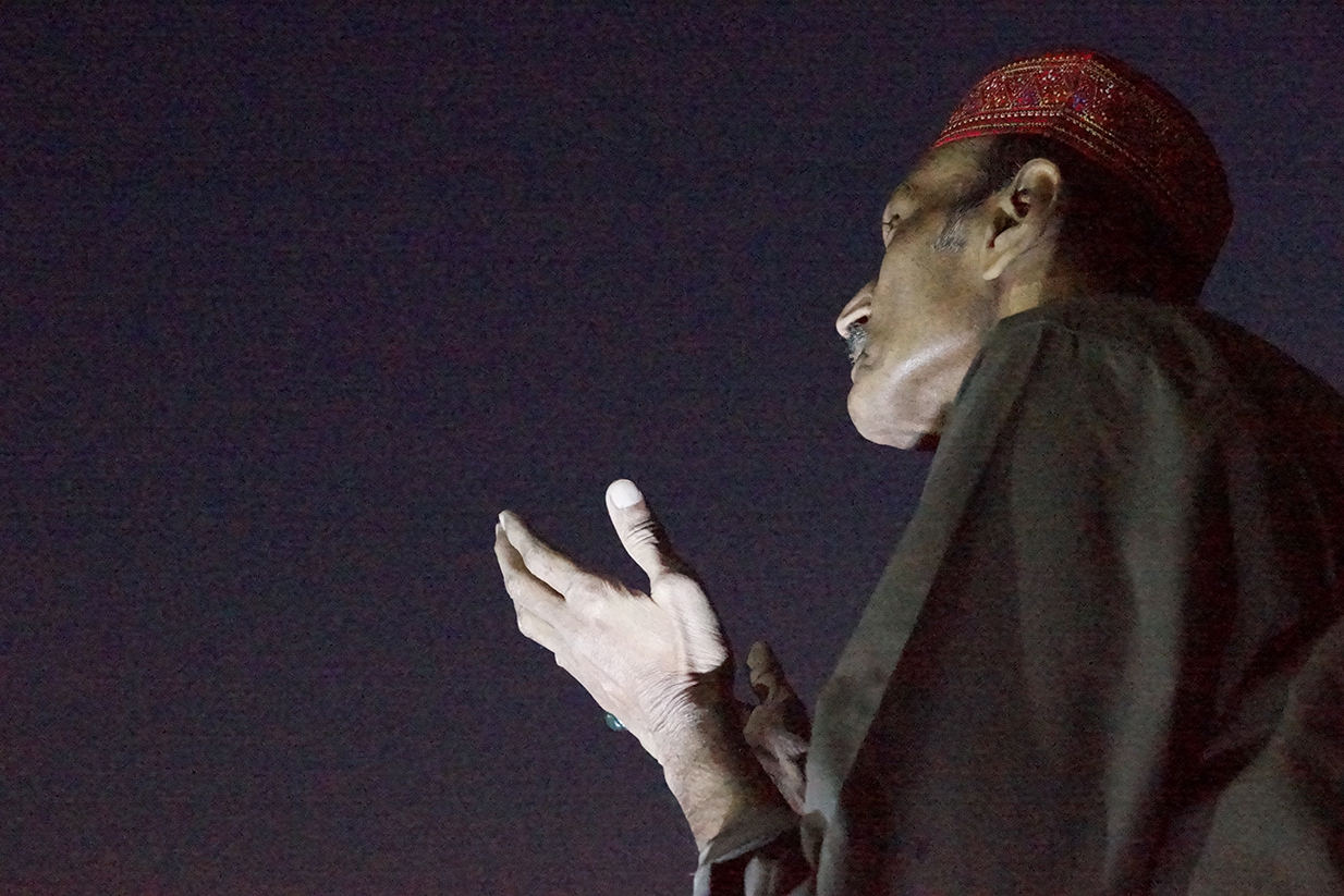 music artist Ustad Saami raising hand and looking up at the sky
